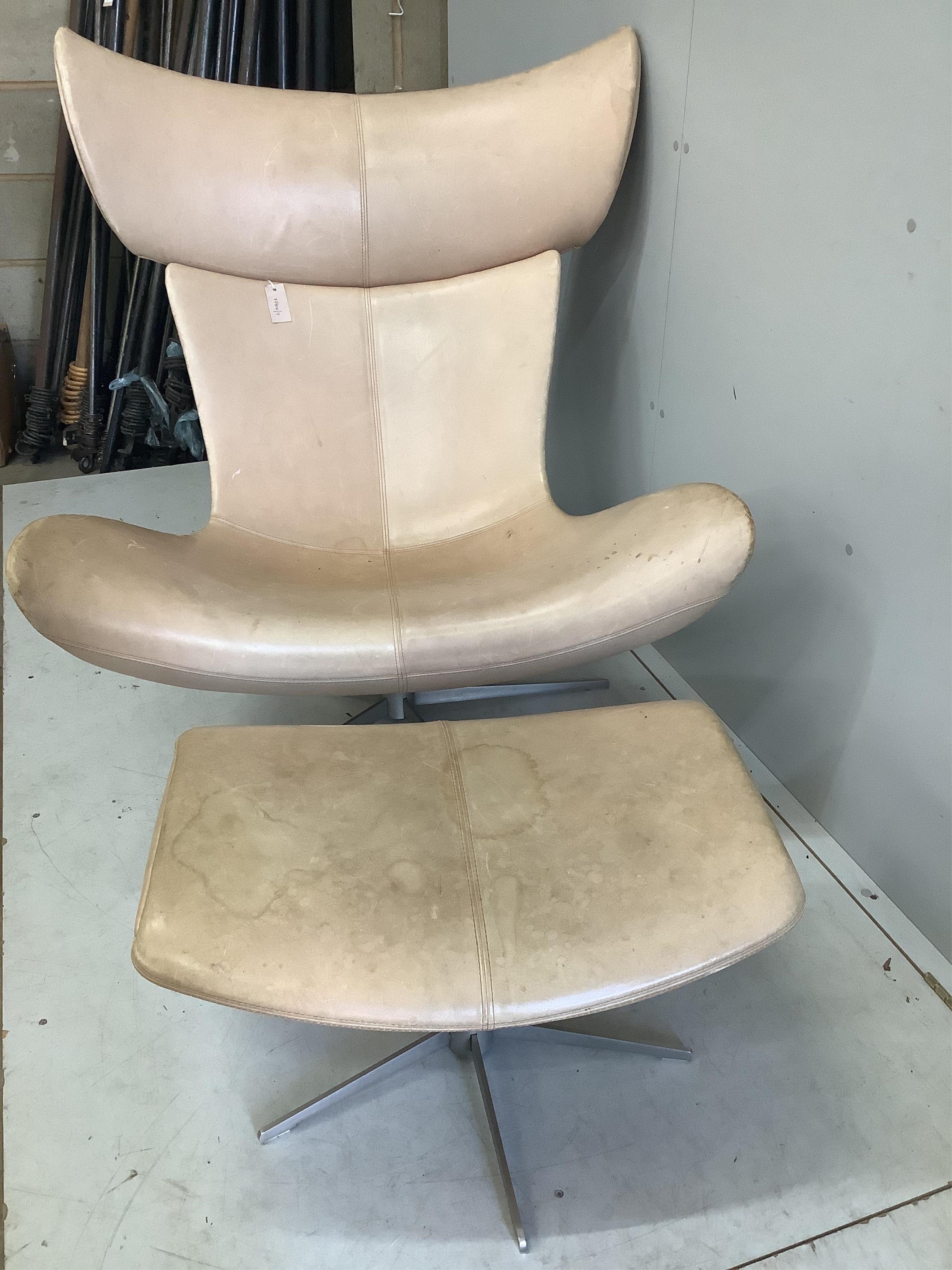 A Bo Concept Imola natural leather swivel chair, width 93cm, depth 90cm, height 110cm and footstool